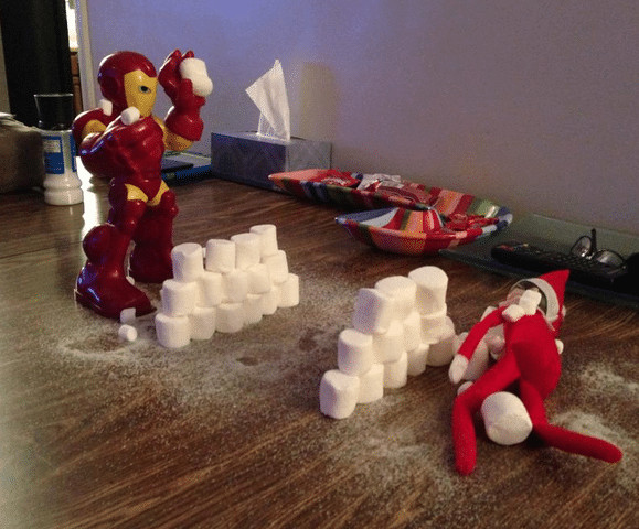 Elf and Iron Man having a snowball fight