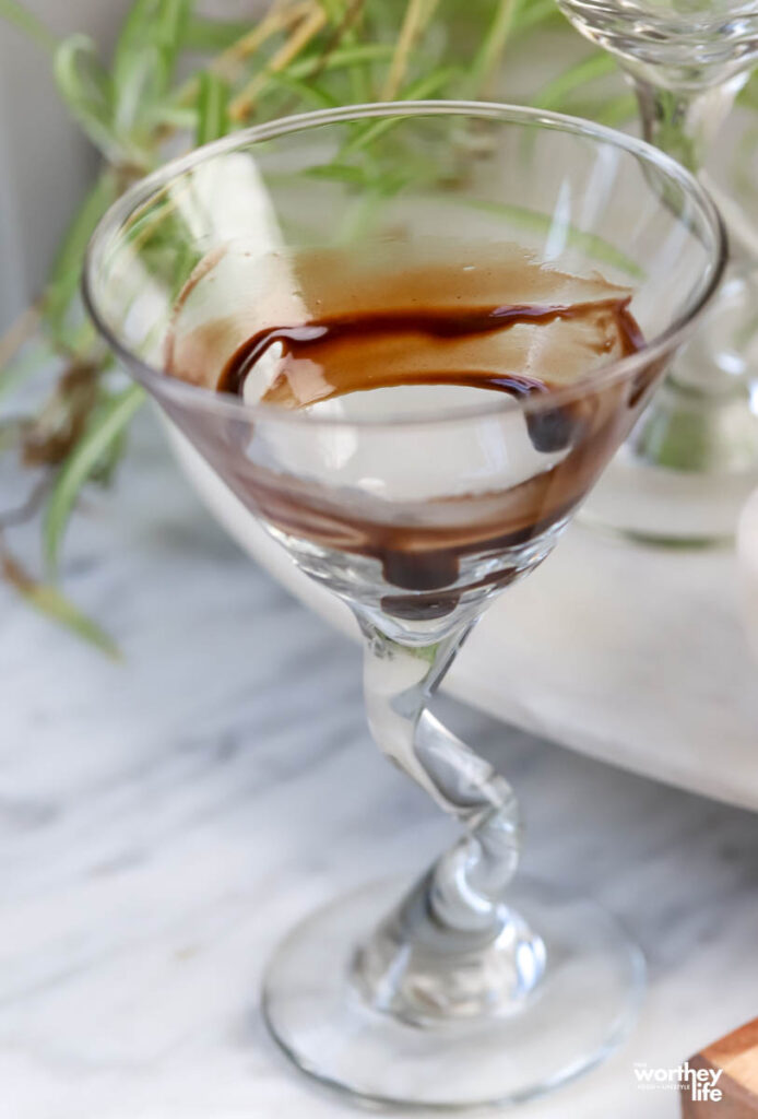 Chocolate syrup swirled in martini glass