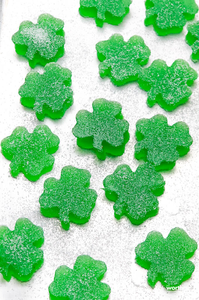 small shamrock gumdrops on a cookie sheet