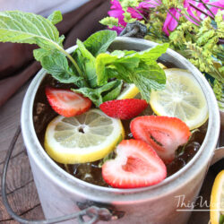 Cool down this summer with our summer tea cocktail. This adult iced tea is filled with strawberries, lemon, Jack Daniels, and mint. Plus, making it in a kettle is an extra bonus! Get the recipe below!