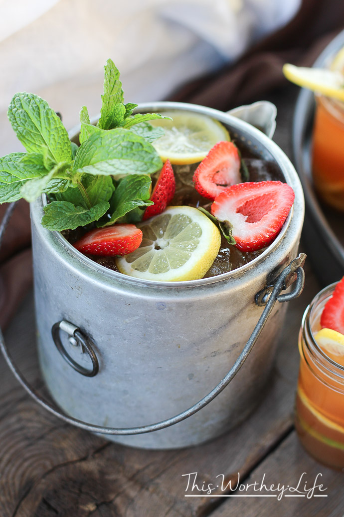 This ice tea is calling your name. Our summer ice tea cocktail has strawberries, Jack Daniels Whiskey, Lemon and mint. Get the recipe on the blog and make this easy summer cocktail today!