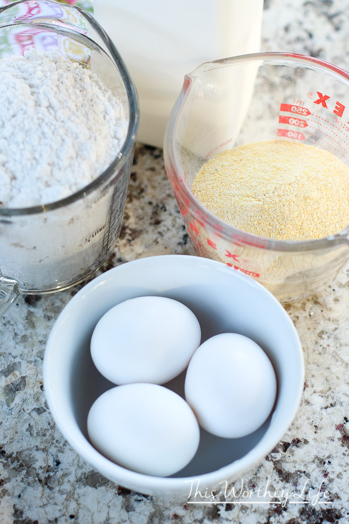 Eggs, cornmeal and flour ingredients to make waffles