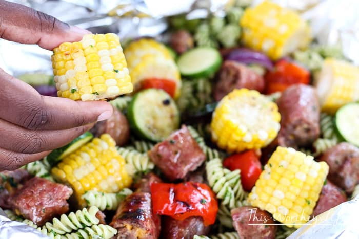 We're celebrating #bratsgiving with a fun twist on the classic crab + shrimp boil foil packets recipe by using pasta with herbs, bratwurst, and fresh veggies. 