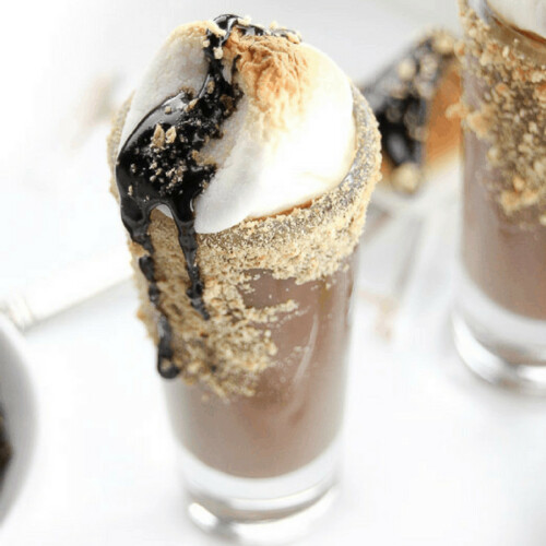 Warm up this winter with a shot of chocolate liqueur, caramel sauce, graham crackers, and chocolate syrup. Our S'mores Hot Chocolate Shots is a way to welcome in the cooler weather. And you can have it made two ways, one for you, and one for the kids. Grab the recipe for our hot chocolate cocktail on the blog!