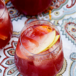 Mix up a batch of our Fall Fruit Sangria and enjoy so many of autumn's favorite fall flavors. It's mixed with slices of sweet apples, ripe plums, peaches, and a mix of slightly bubbly Rosé and delicious apple cider. The whole thing is sweetened with our homemade Blueberry + Cranberry Simple Syrup. 