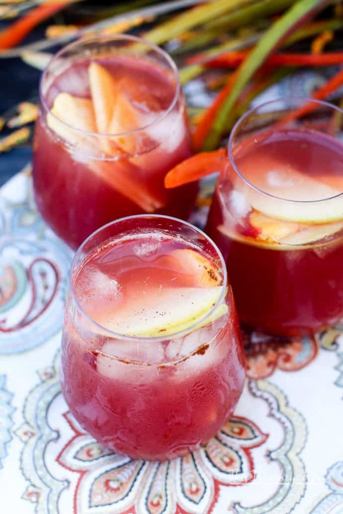 Mix up a batch of our Fall Fruit Sangria and enjoy so many of autumn's favorite fall flavors. It's mixed with slices of sweet apples, ripe plums, peaches, and a mix of slightly bubbly Rosé and delicious apple cider. The whole thing is sweetened with our homemade Blueberry + Cranberry Simple Syrup. 