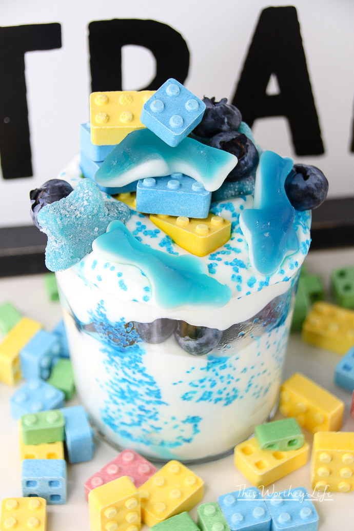 Create a fun and healthy snack for the kids. This lego + blue shark parfait is a fun treat any child will enjoy. Lego toys are super popular with kids, and so will this lego food recipe idea! It's a great lego birthday snack, or to serve during shark week! 