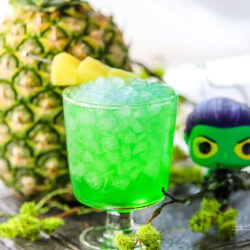 This fun kid-friendly green drink has pineapple juice, green apple syrup, and lemon-lime soda to make a Guardians of the Galaxy drink featuring Gamora! Check out how to make this fun green pineapple mocktail on our recipe blog.