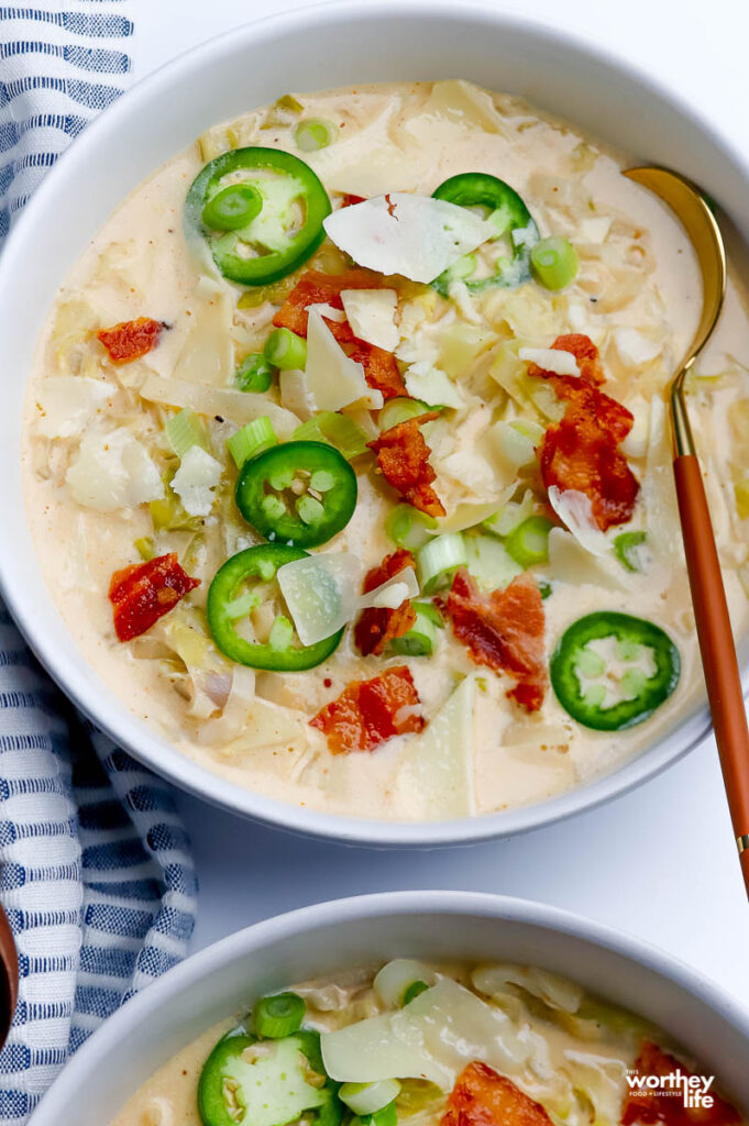 bowl of cabbage soup on a white background