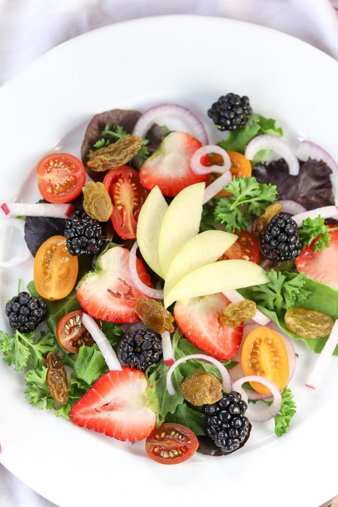  With loads of fresh and local fruit all around us, it's the perfect time to make a summer salad. Try our Berry + Apple Summer salad, loaded with strawberries, berries, tomatoes, mixed salad greens and more. grab the recipe down below. 