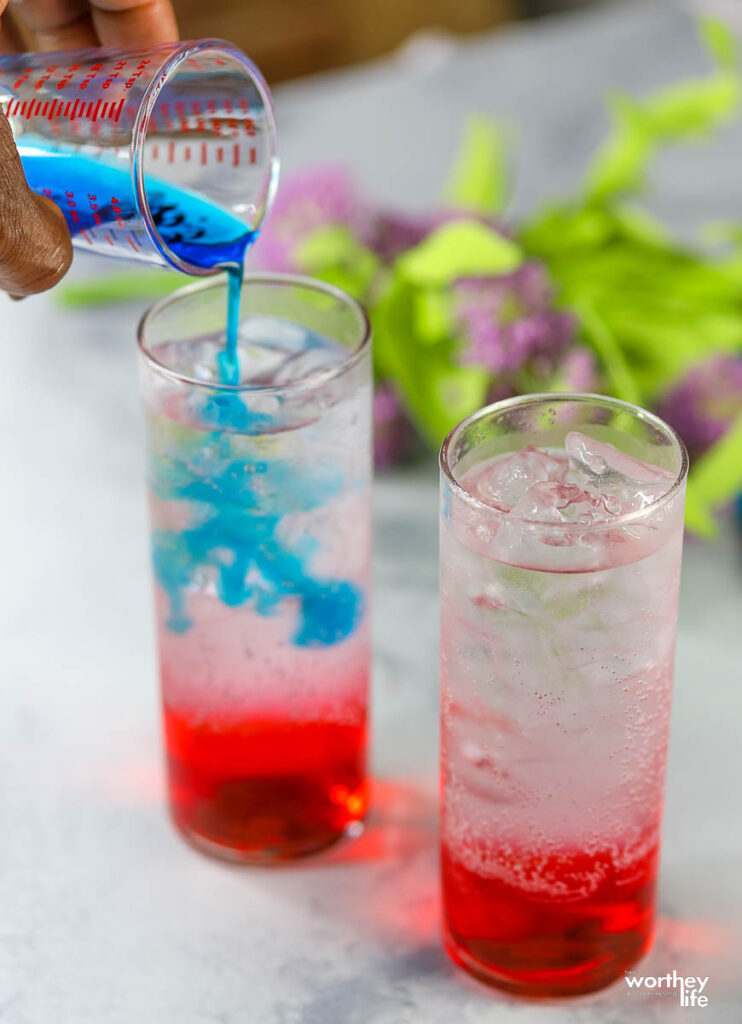 pouring blue syrup in glass