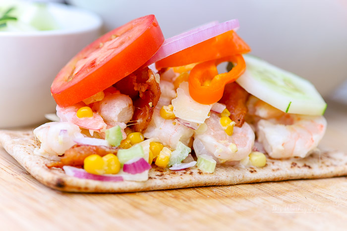 This po' boy sandwich is made with shrimp made with a mixture of mayo, fried sweet corn, diced radish, celery, and parmesan, served on flatbread. This Shrimp Po' Boy is great to serve with a side of Cape Cod chips, the type of appetizer you serve on a summer afternoon, a day at the beach, or just because you're craving a po' boy!