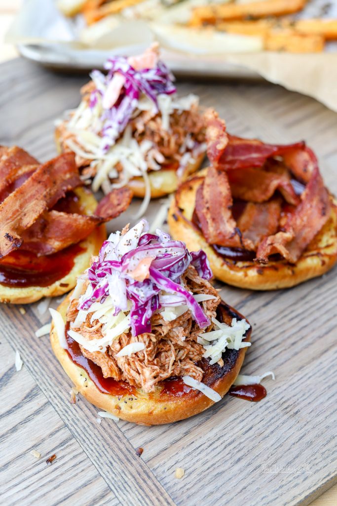 BBQ Pulled Chicken Sandwiches are a great appetizer for game day parties, BBQ outings, and any other time when you're feeling in the mood for BBQ chicken. Topped with coleslaw and bacon, you can't go wrong with these Kansas City BBQ Pulled Chicken Sandwiches.
