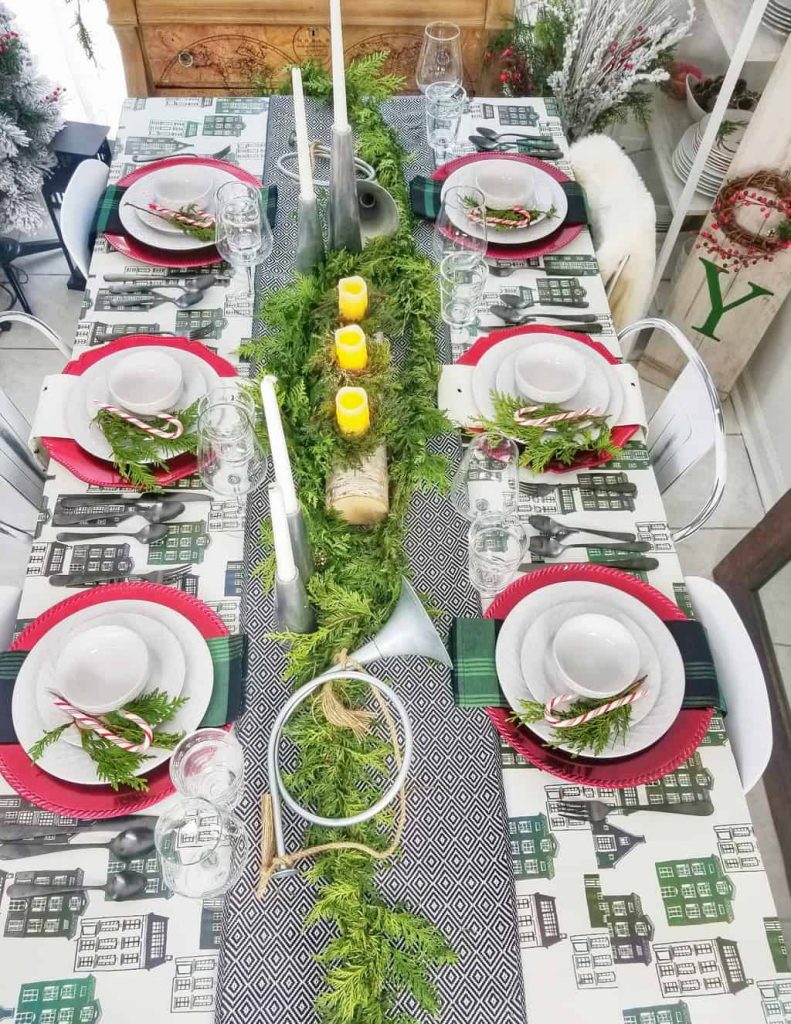 Are you a fan of HGTV's Fixer Upper couple, Chip & Jo? If so, you will love our Green + Black + Red Magnolia Themed Tablescape for the holidays. This table decor idea is inspired by their Hearth & Hand Magnolia Houseware line. Grab the details on the blog!