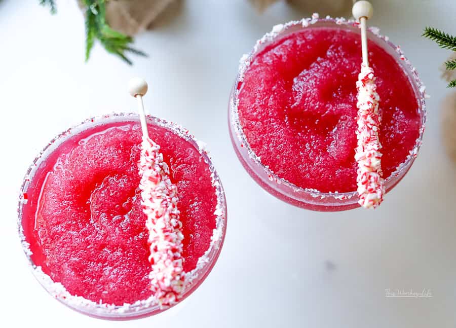 Our Frozen Cranberry Margarita is a festive holiday cocktail, arriving just in time to greet St. Nick and your Christmas party festivities. We're adding a peppermint rim to this Cranberry Margarita.