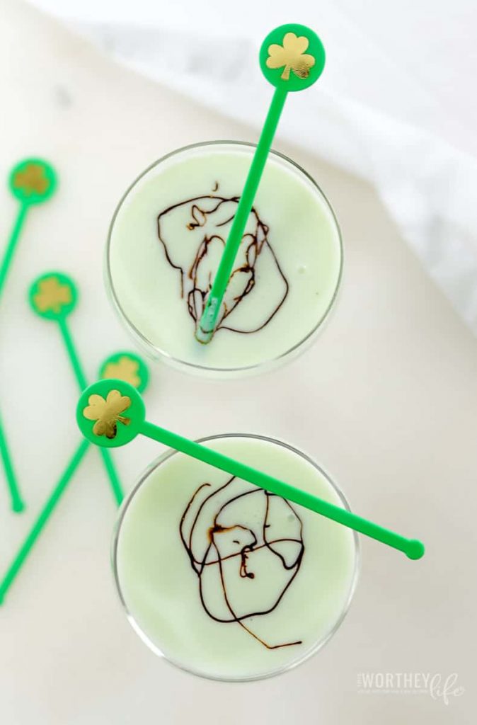 two green cocktails in cocktail glasses on white background