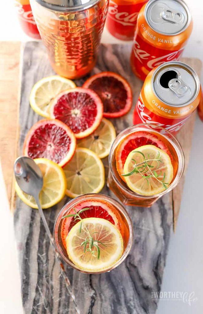 With the new Coca-Cola® Orange Vanilla available now, I've created a Citrus Rye Honey Cocktail with this new flavor. Made with honey, rye, orange bitters, and orange curacao, this will be a cocktail you will want to add to your summer playlist of drinks.