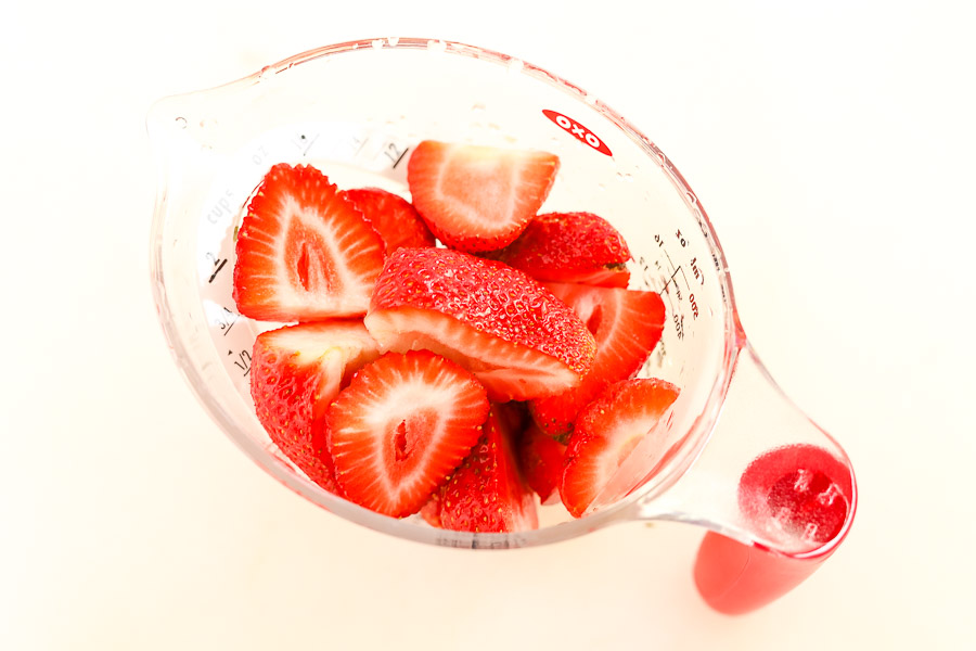 fresh strawberries in measuring cup
