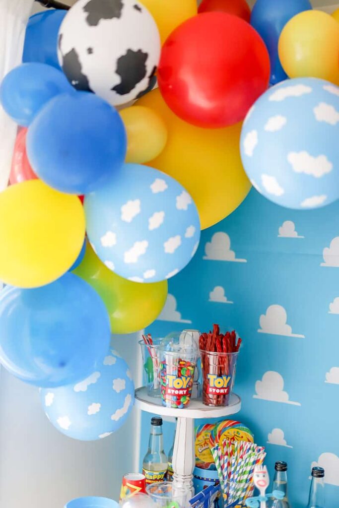 Plan a fun Toy Story themed party with a Toy Story Balloon garland. I'm sharing how to create a balloon garland with a Toy Story theme. It's the perfect pop to any themed party.