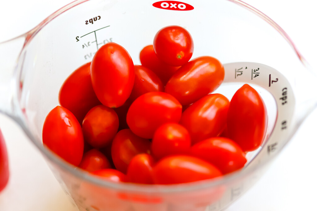 fresh tomatoes in a measuring cup