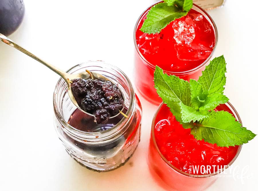 Mulberry Simple Syrup in glass jar with cocktails