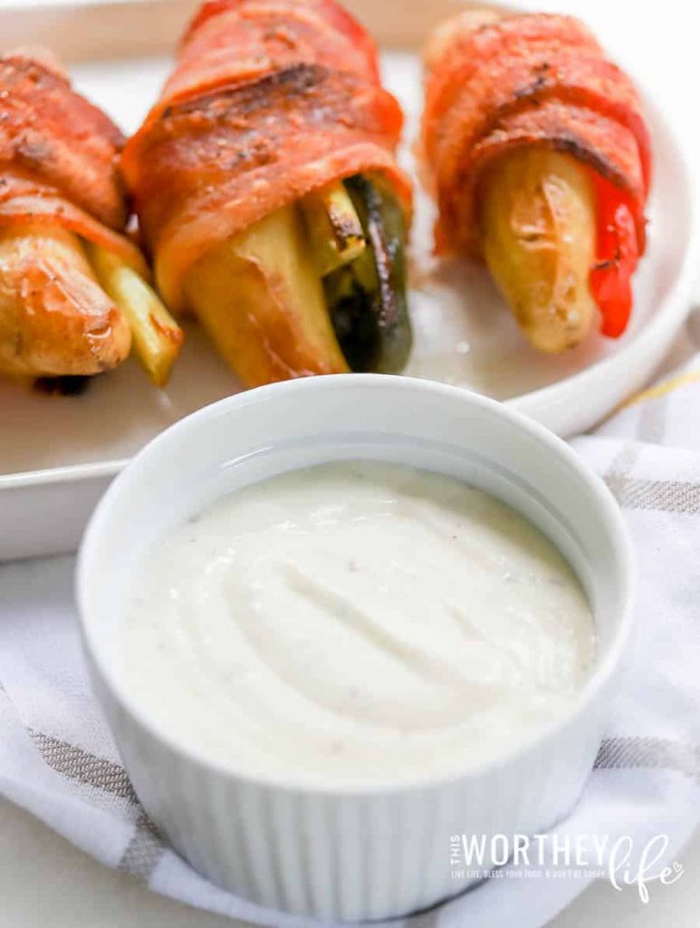 Bacon-Wrapped Potatoes + Veggies are the perfect tailgating treat. Savory, Salty, Crispy, and made with your favorite veggies. And the Herb Ranch Horseradish dipping sauce is a combination.