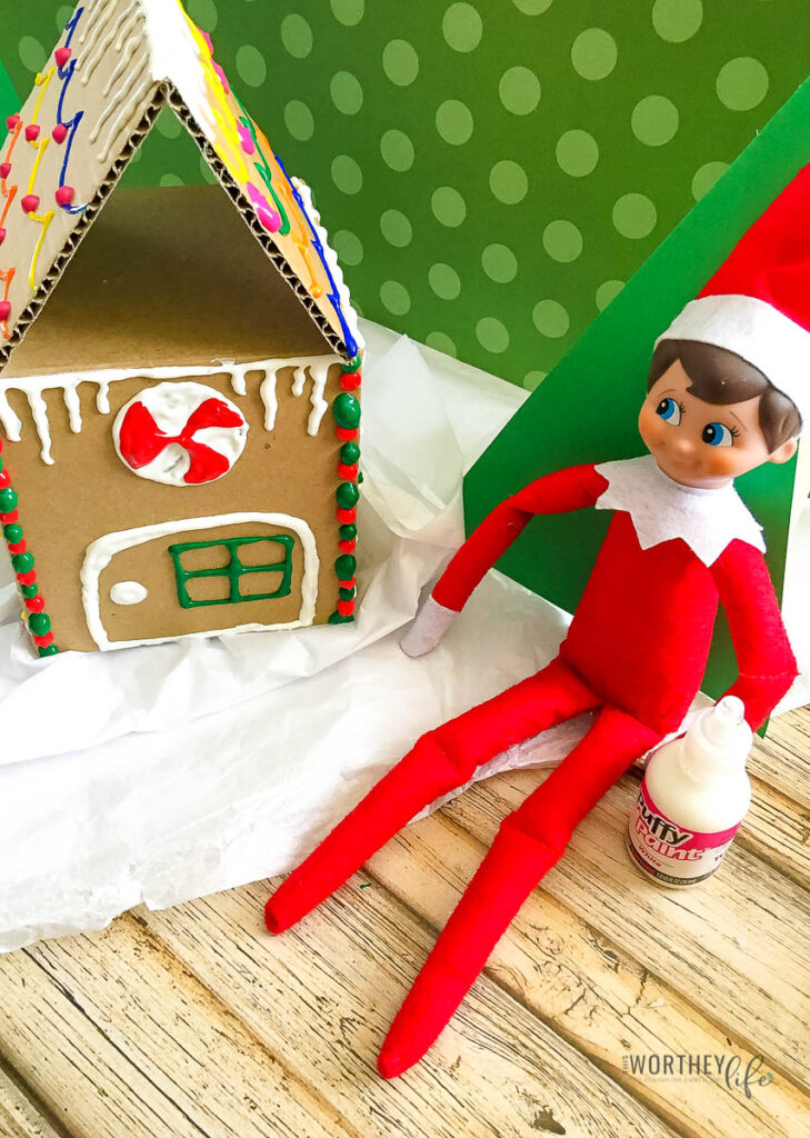 Elf Builds A Gingerbread House