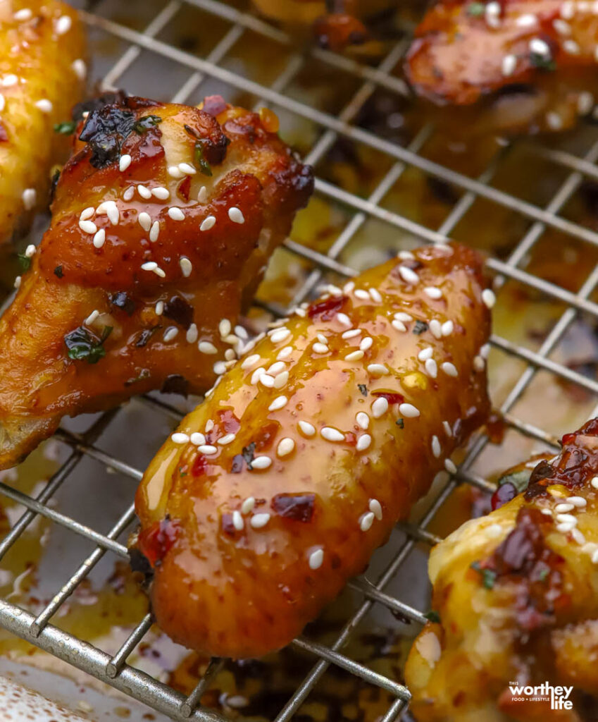 Air fryer chicken wings on a wire rack and sheet pan. 