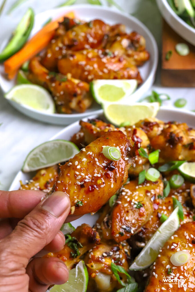 Man holding a thai wing