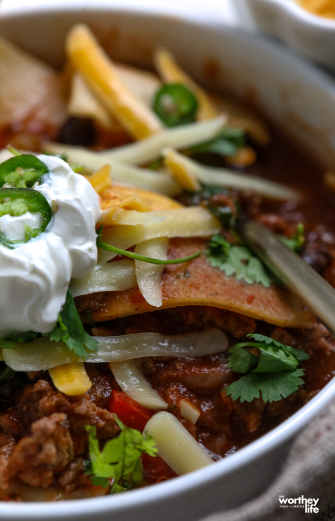 soup topped with cheese, sour cream, jalepenos