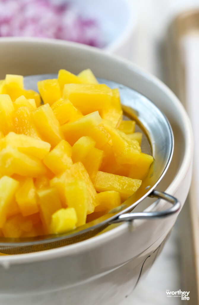 fresh diced pineapple on strainer