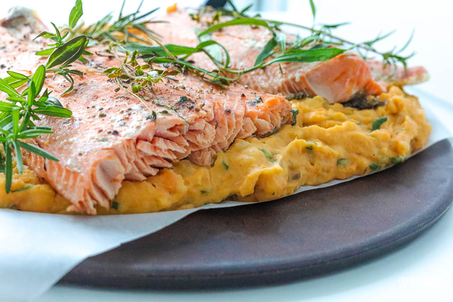 Baked Salmon resting on savory potatoes