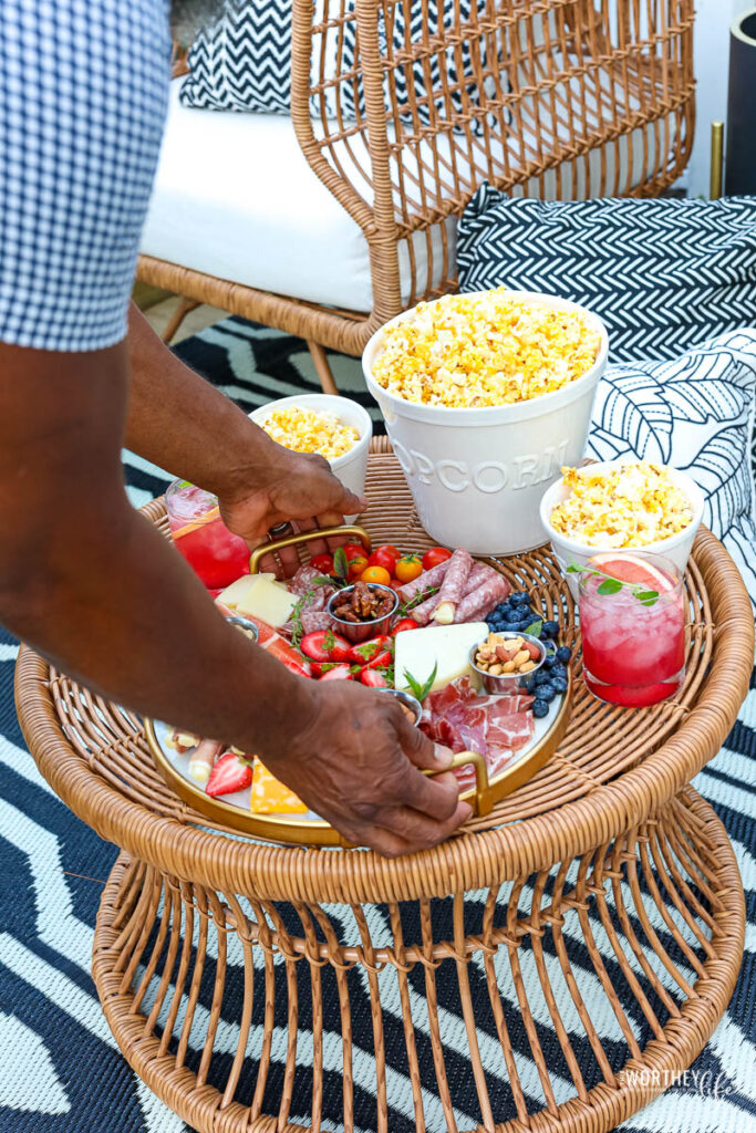 man putting down charcuterie board