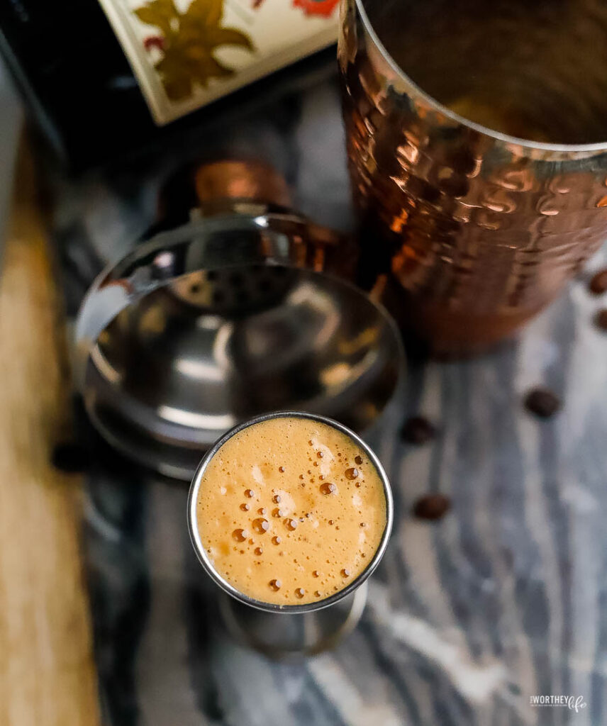 a cup of coffee with a cocktail shaker