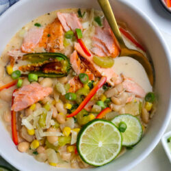 salmon chili in a white bowl topped with slices of lime