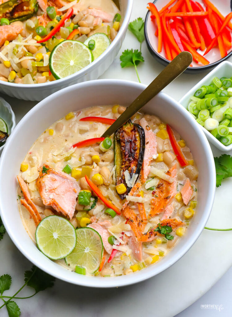 white chili salmon in a white bowl with fresh veggies