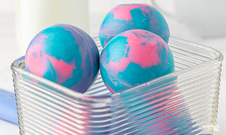 cotton candy hot cocoa bombs in a clear glass