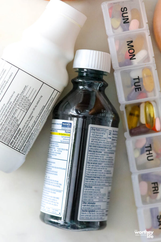 bottles of medicine laying sideways on a white background