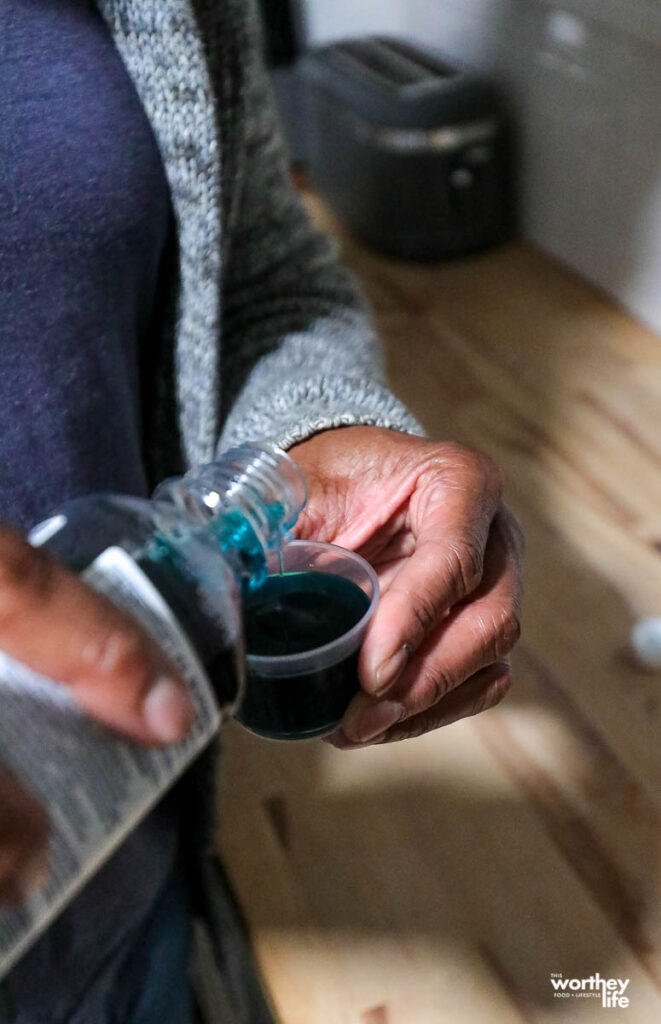 african american man holding medicine in a bottle