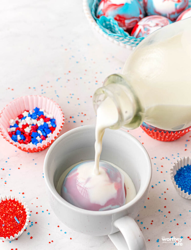 hot cocoa bomb in a white cup with milk