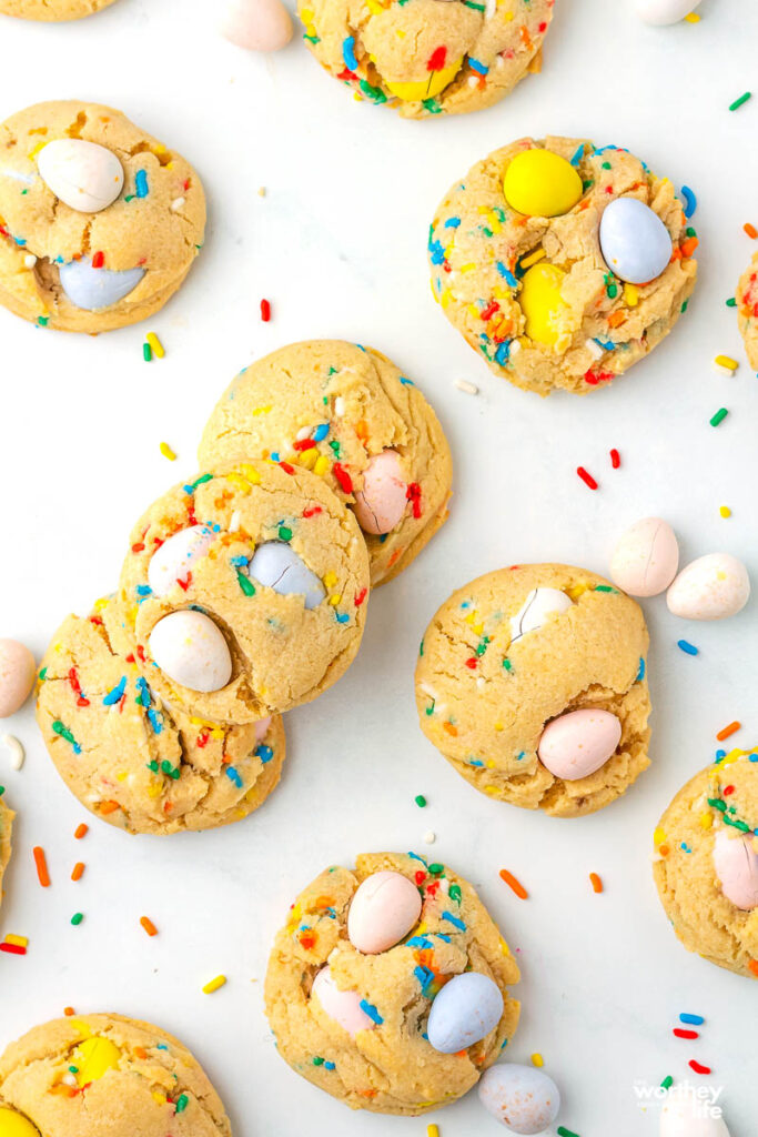 mini egg cookies spread out on a white background