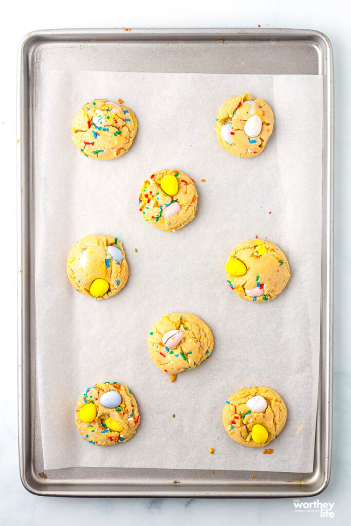 Cadbury Mini Egg Cookies on a baking sheet with parchment paper