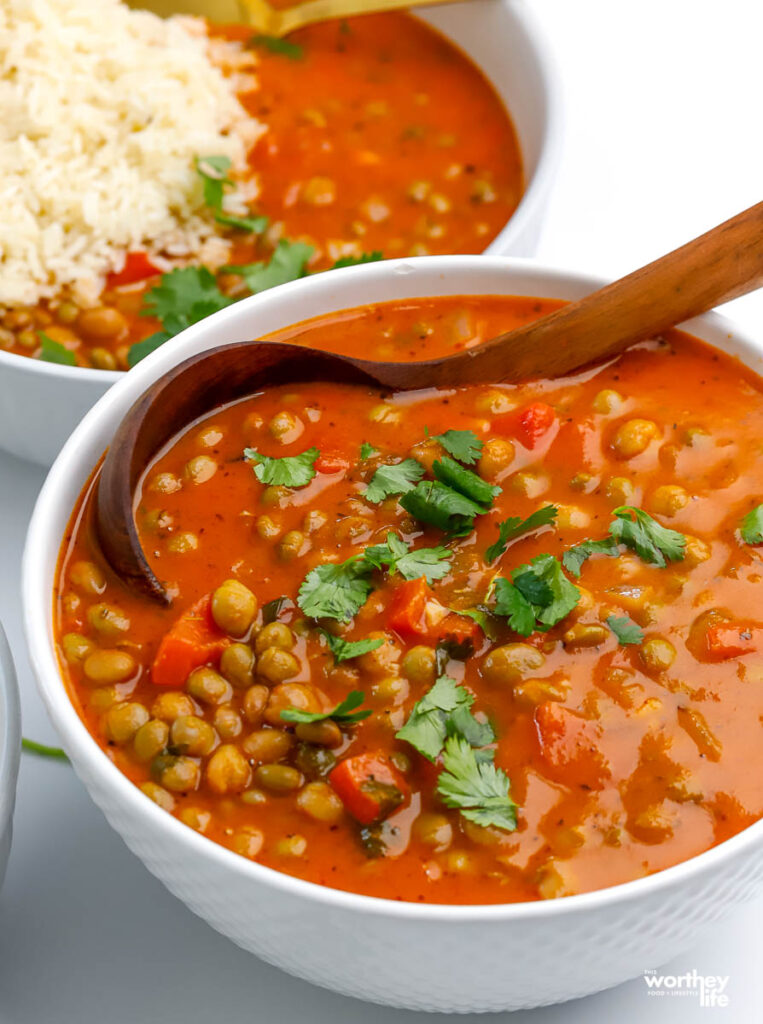 a white serving bowl filled with pigeon pea stew 