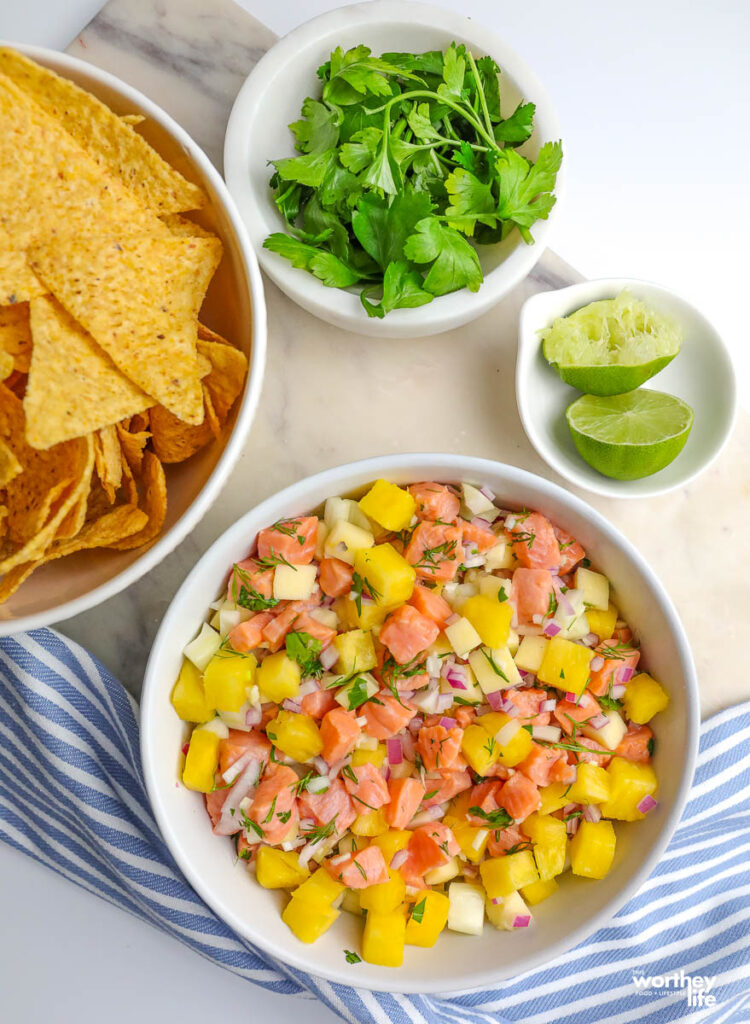 ceviche and corn tortilla chips served with lime and fresh cilantro