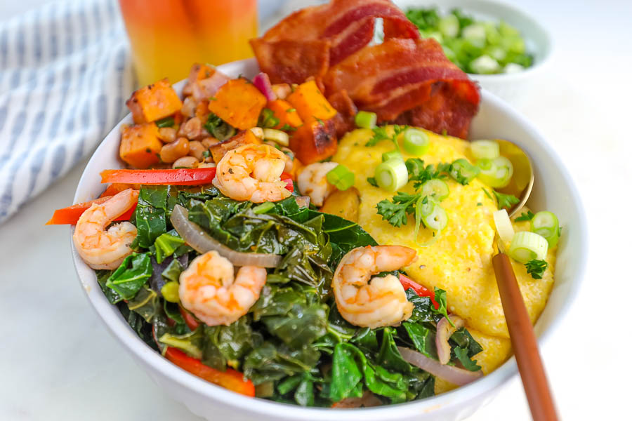 greens, sweet potatoes and shrimp in a white bowl
