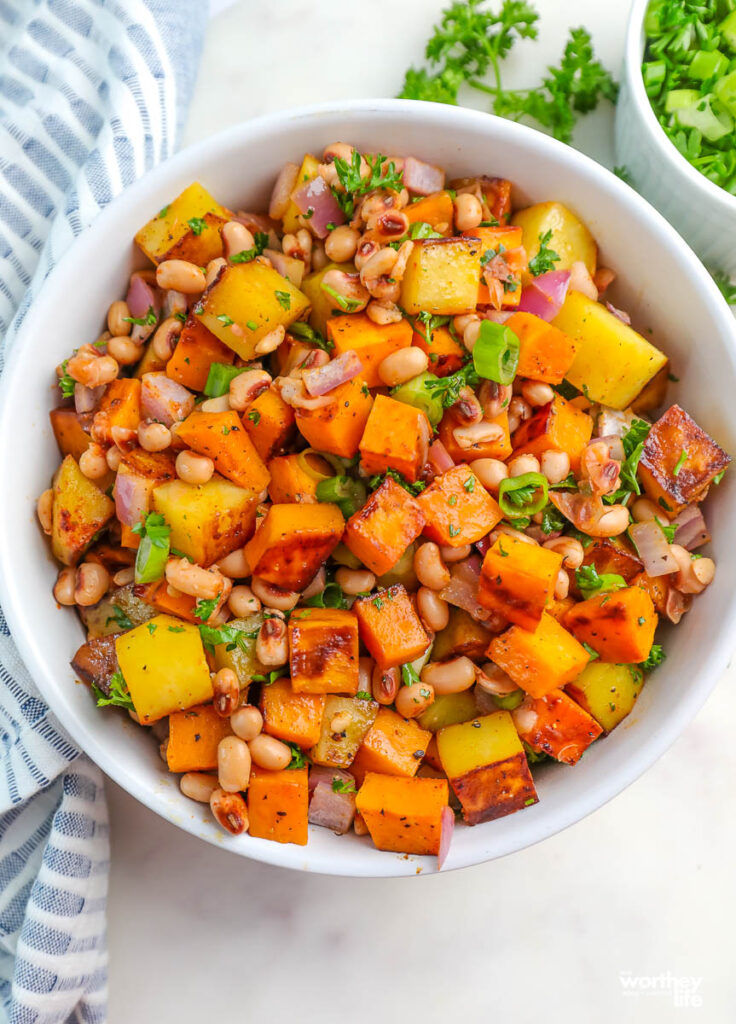 large white bowl with sweet potato black eyed pea hash