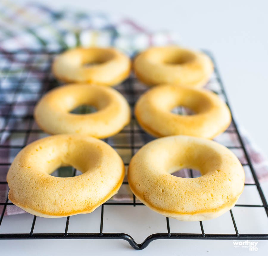 freshly baked lemon donuts on a cooling rack