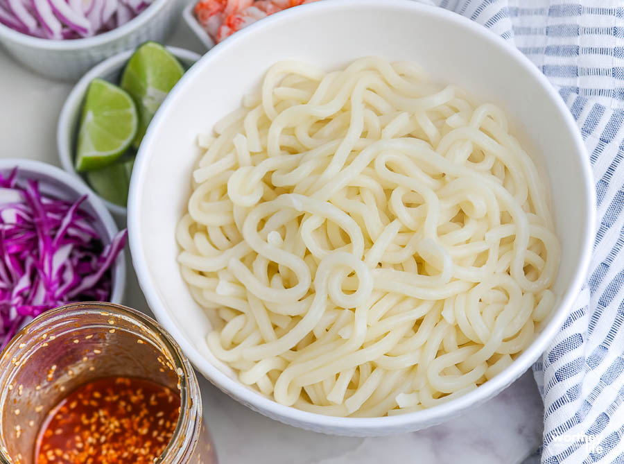 thick noodles in a white bowl