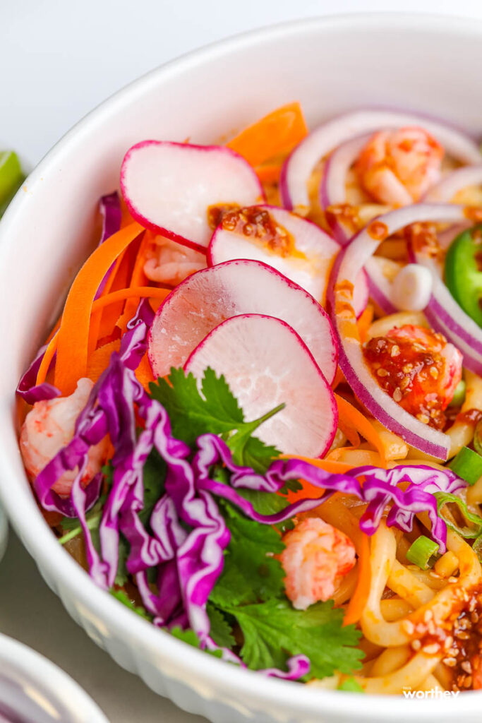 seafood soba noodle salad topped with fresh vegetables and an Asian vinaigrette
