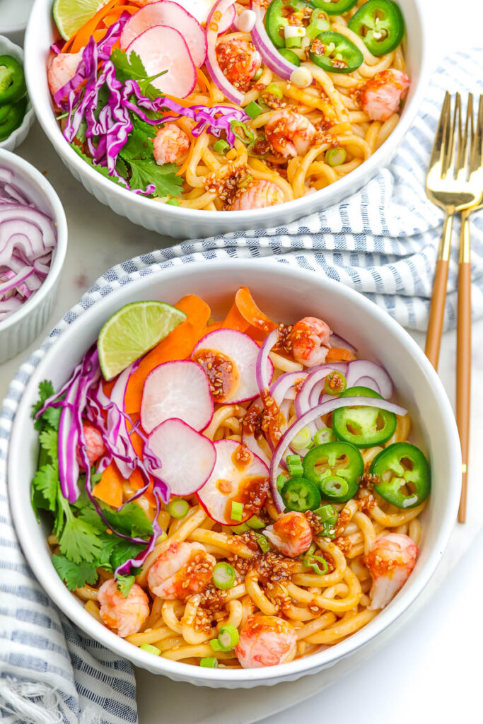 two white bowls of seafood soba noodle salad
